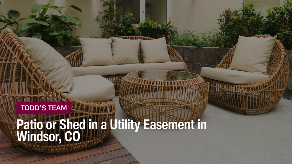Wicker patio furniture on a paved backyard patio, the kind of patio or shed in a utility easement Windsor CO sellers have